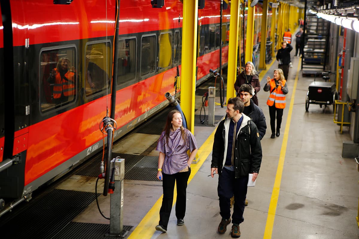 Asistentes recorriendo el andén del taller junto al tren DSB EC.